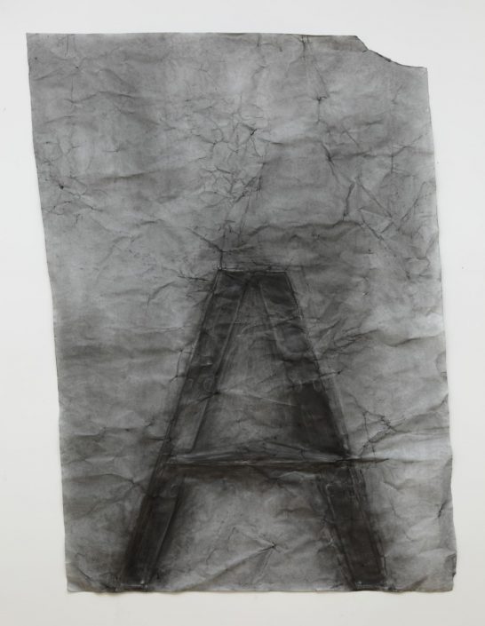 Charcoal rubbing of ladder in profile, heavily embedding its image into paper that has become reminiscent of crumbling stone as a result of the drawing process.